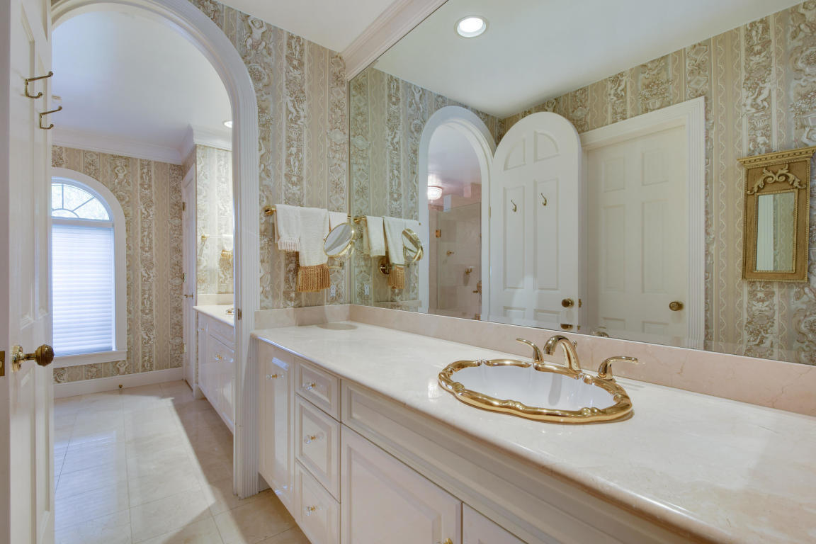 6318 Woodbury Road Boca Raton, FL 33433 - Photo 23 of 52 a bathroom with a sink and a mirror