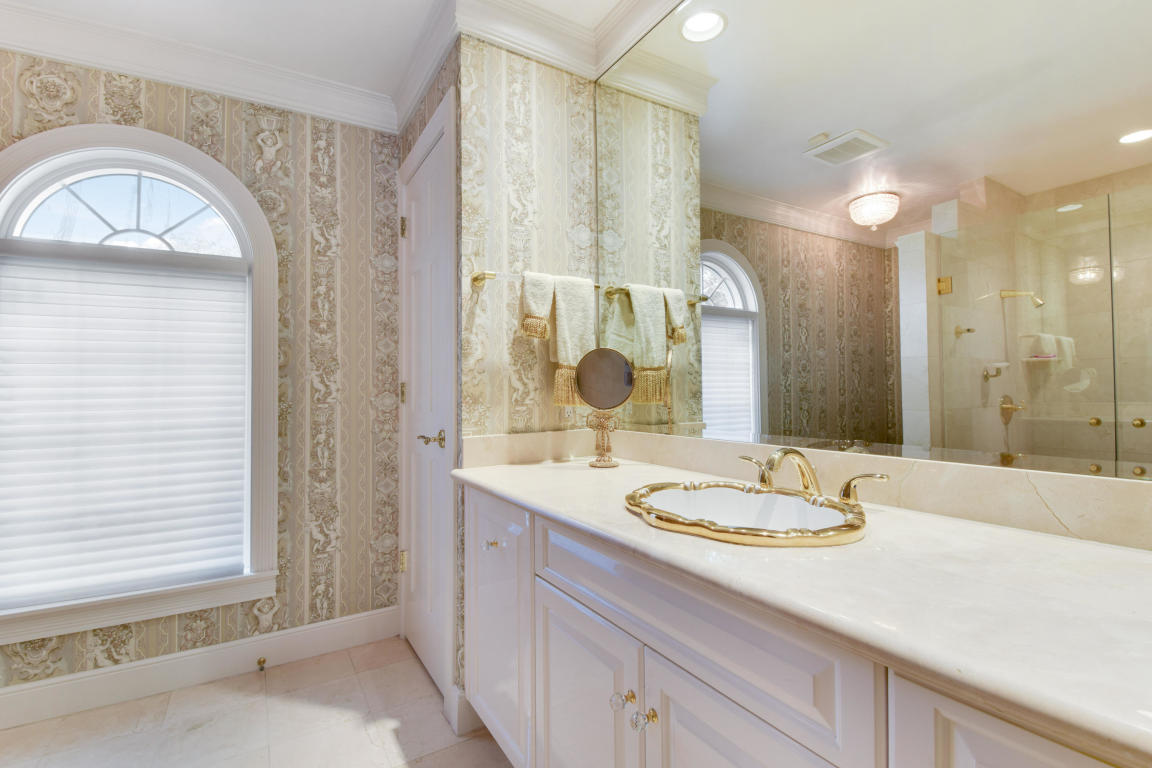 6318 Woodbury Road Boca Raton, FL 33433 - Photo 24 of 52 a bathroom with a granite countertop sink and a mirror
