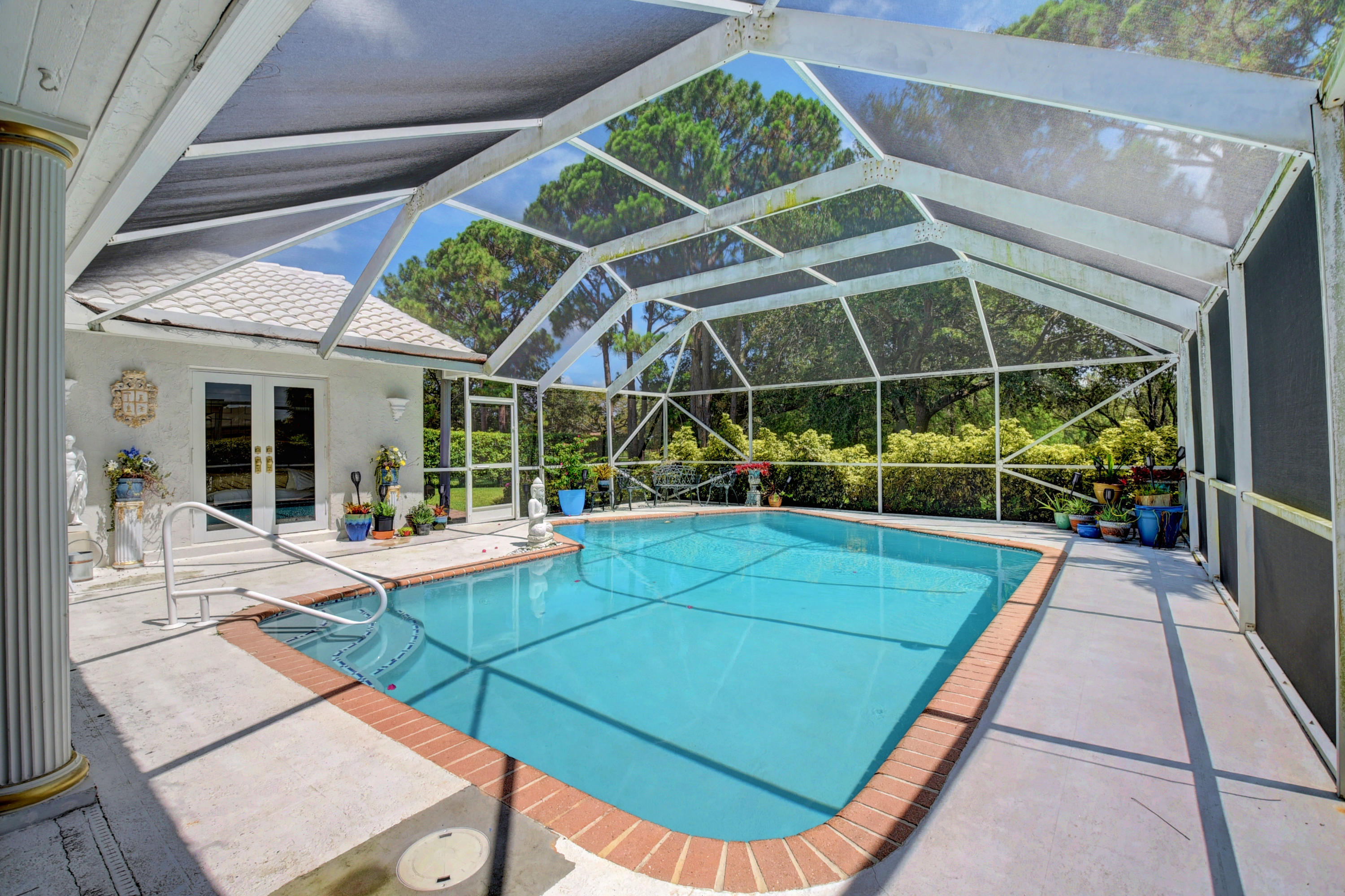 6318 Woodbury Road Boca Raton, FL 33433 - Photo 33 of 52 a view of a patio with a table and chairs