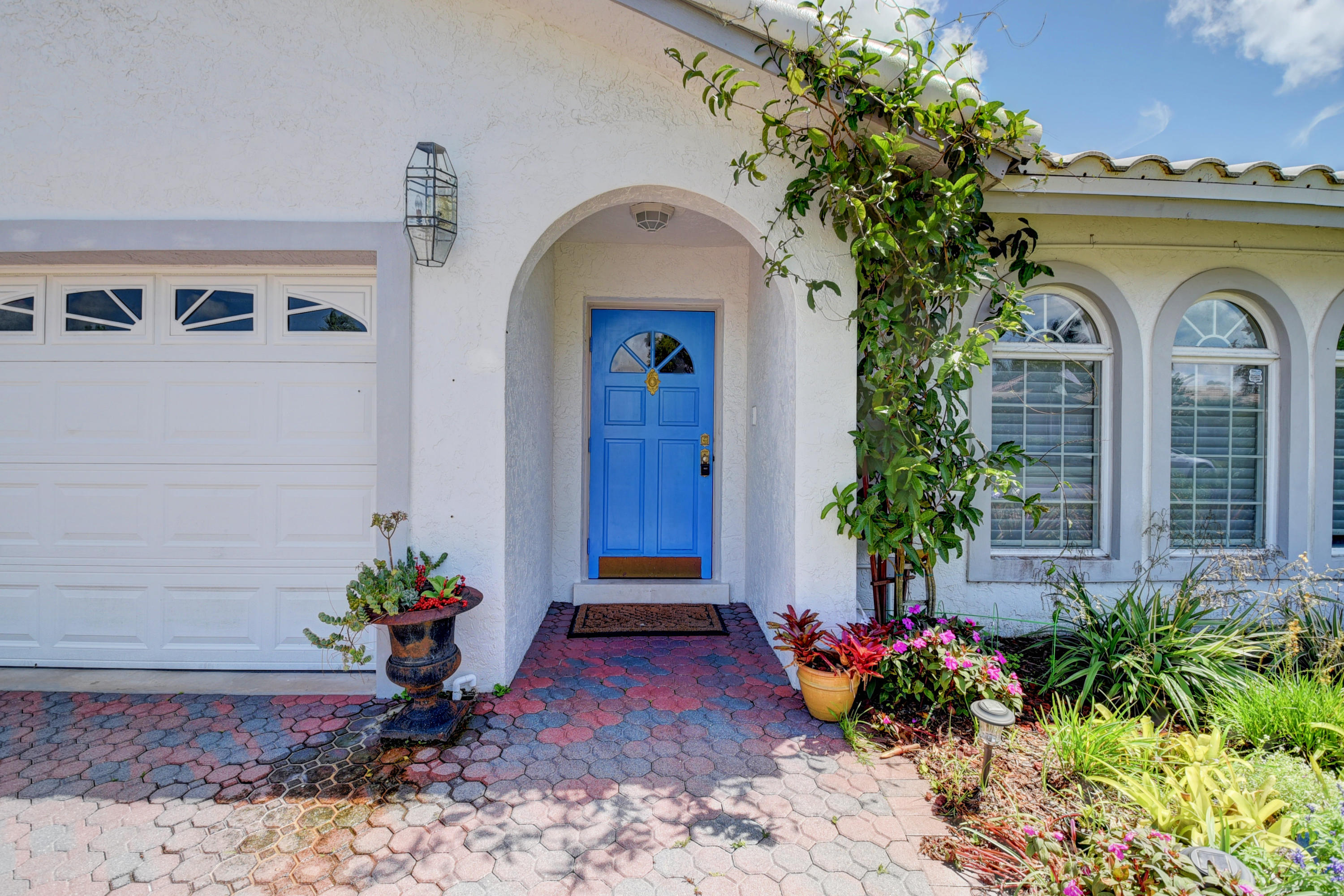 6318 Woodbury Road Boca Raton, FL 33433 - Photo 4 of 52 a front view of a house with garden