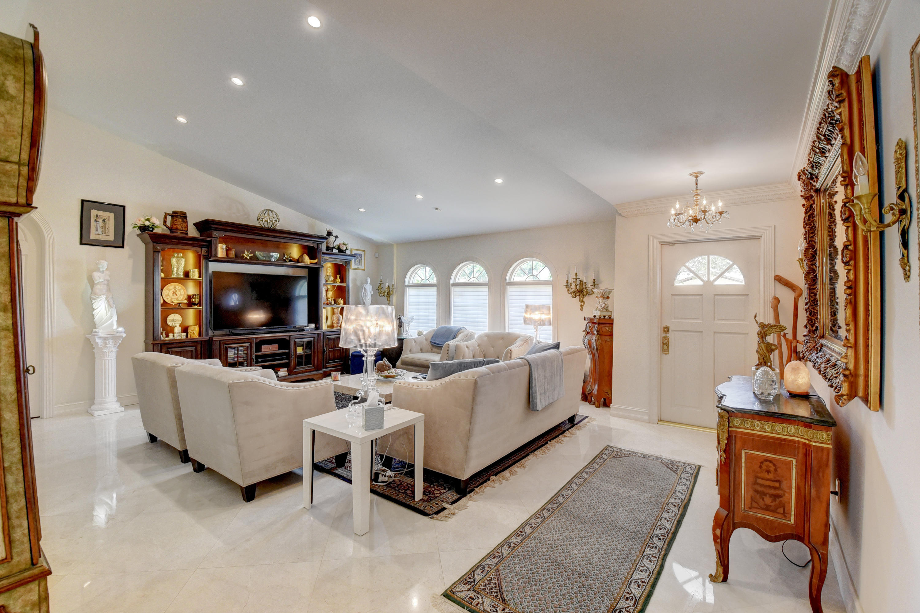 6318 Woodbury Road Boca Raton, FL 33433 - Photo 5 of 52 a living room with furniture a flat screen tv and a fireplace