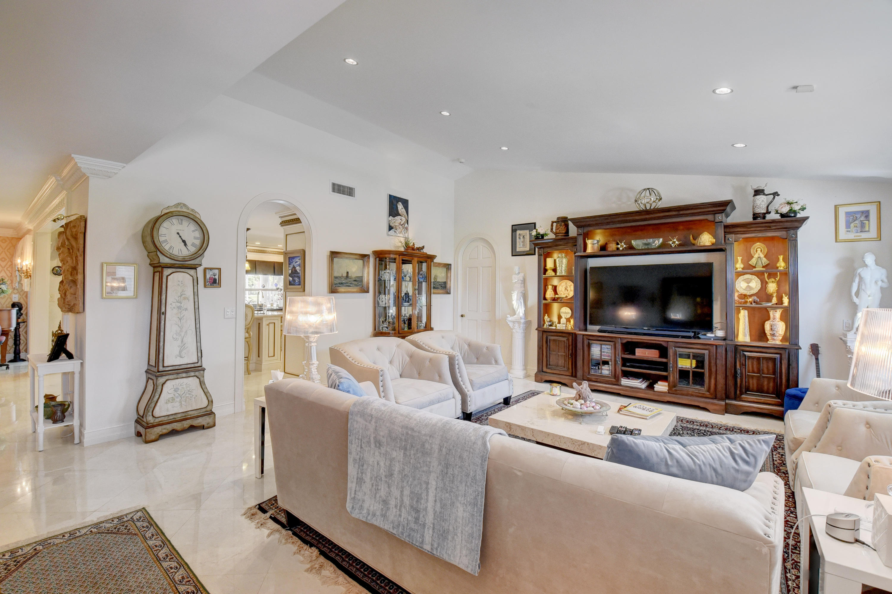 6318 Woodbury Road Boca Raton, FL 33433 - Photo 6 of 52 a living room with furniture and a flat screen tv