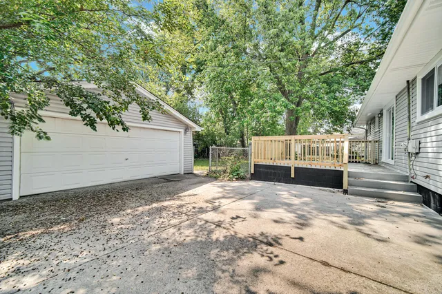 a view of a house with a wooden fence