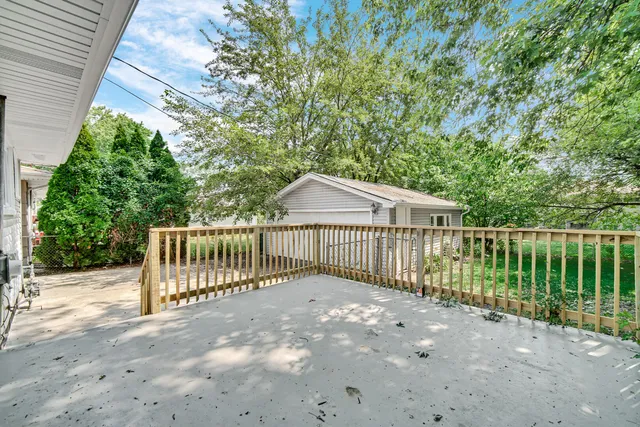 a view of a house with a backyard and a patio