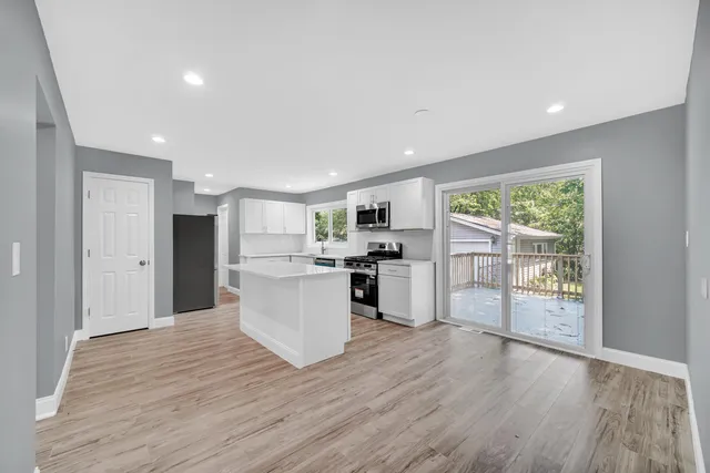 a view of a kitchen with wooden floor
