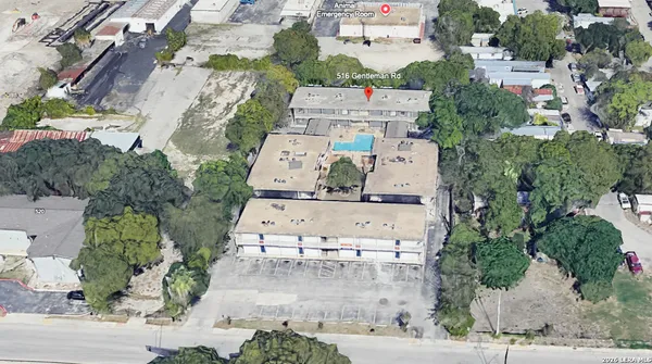 an aerial view of residential houses with outdoor space