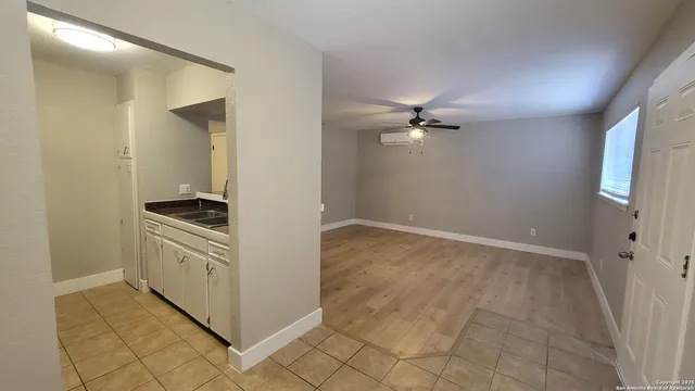 a view of a kitchen with a sink and a stove top oven