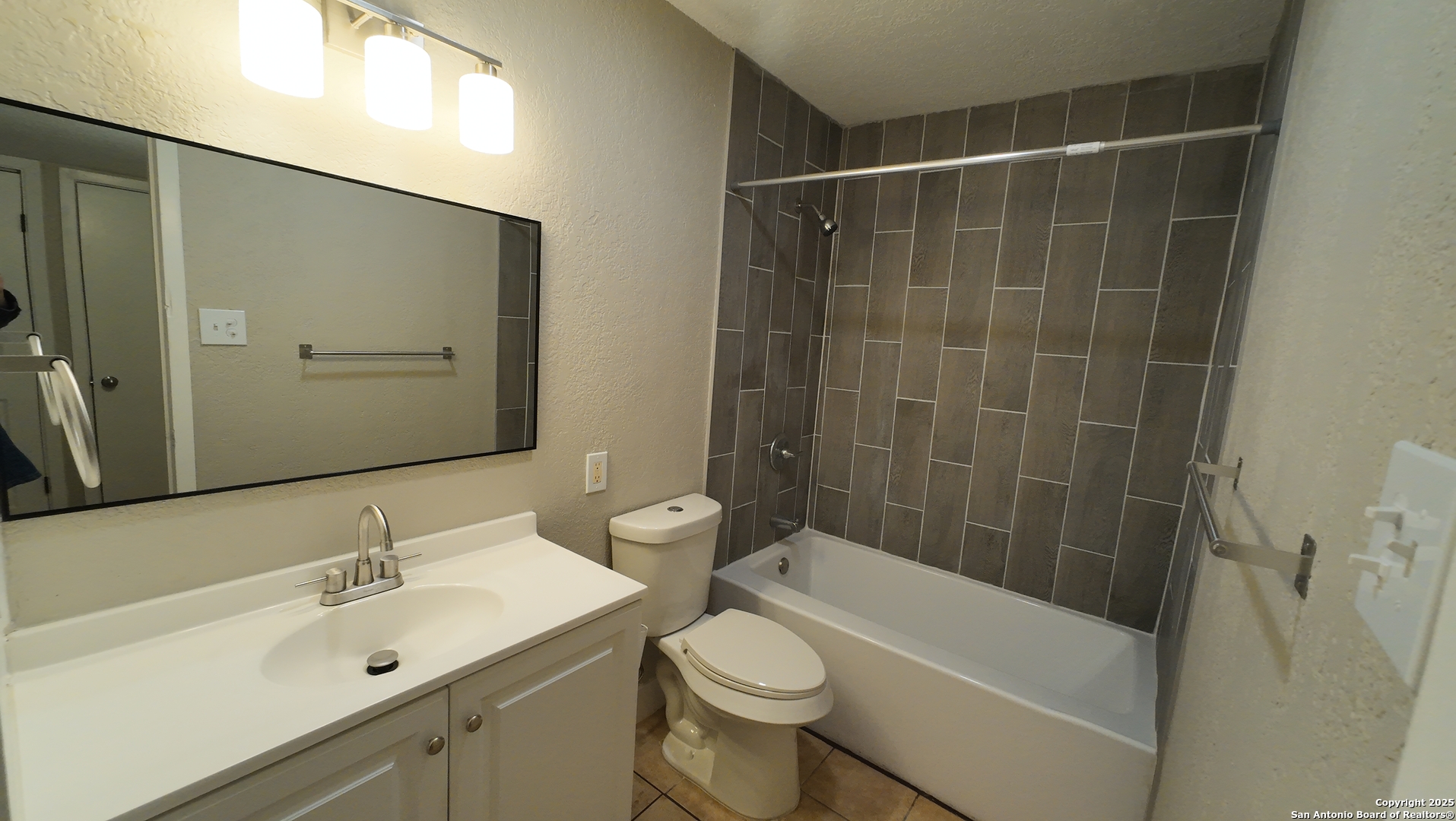 516 Gentleman Road, Unit 15 San Antonio, TX 78201 - Photo 9 of 12 a bathroom with a sink a toilet and shower