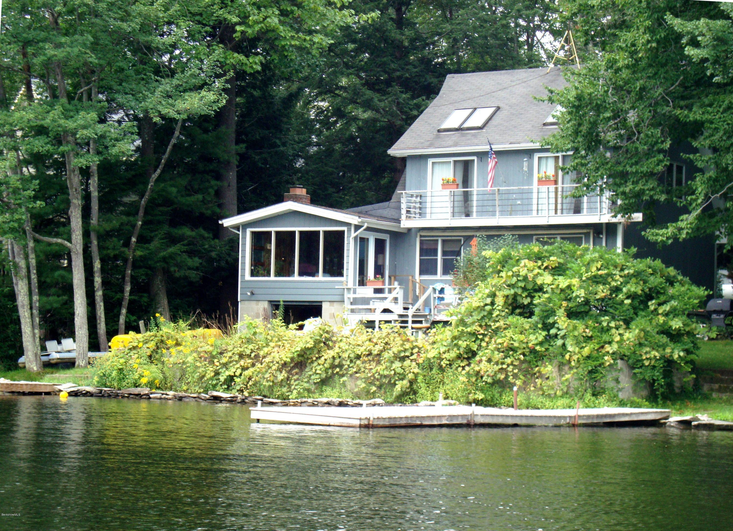 25 Point Road Monterey, MA 01245 - Photo 1 of 19 a front view of a house with a yard from a lake