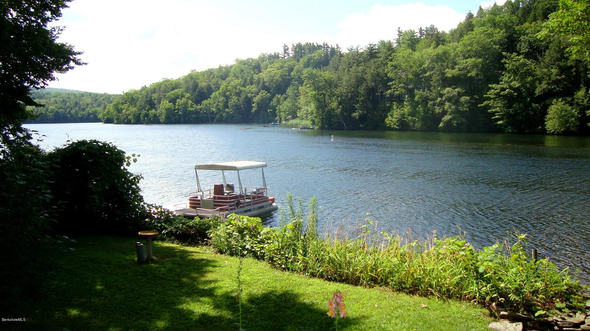 25 Point Road Monterey, MA 01245 - Photo 2 of 19 a backyard of a house with lots of green space and lake view