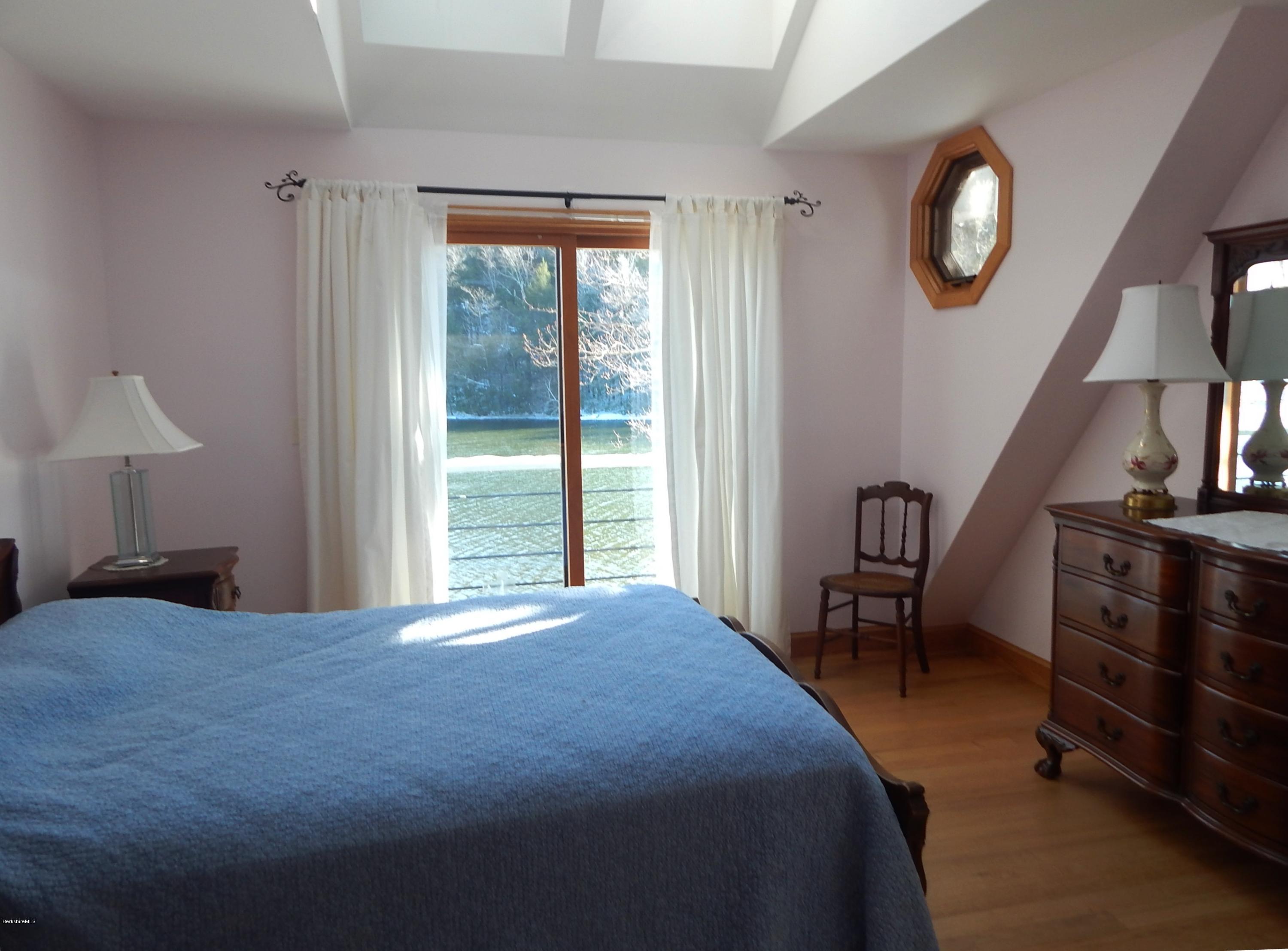 25 Point Road Monterey, MA 01245 - Photo 12 of 19 a bedroom with a bed and a table in it
