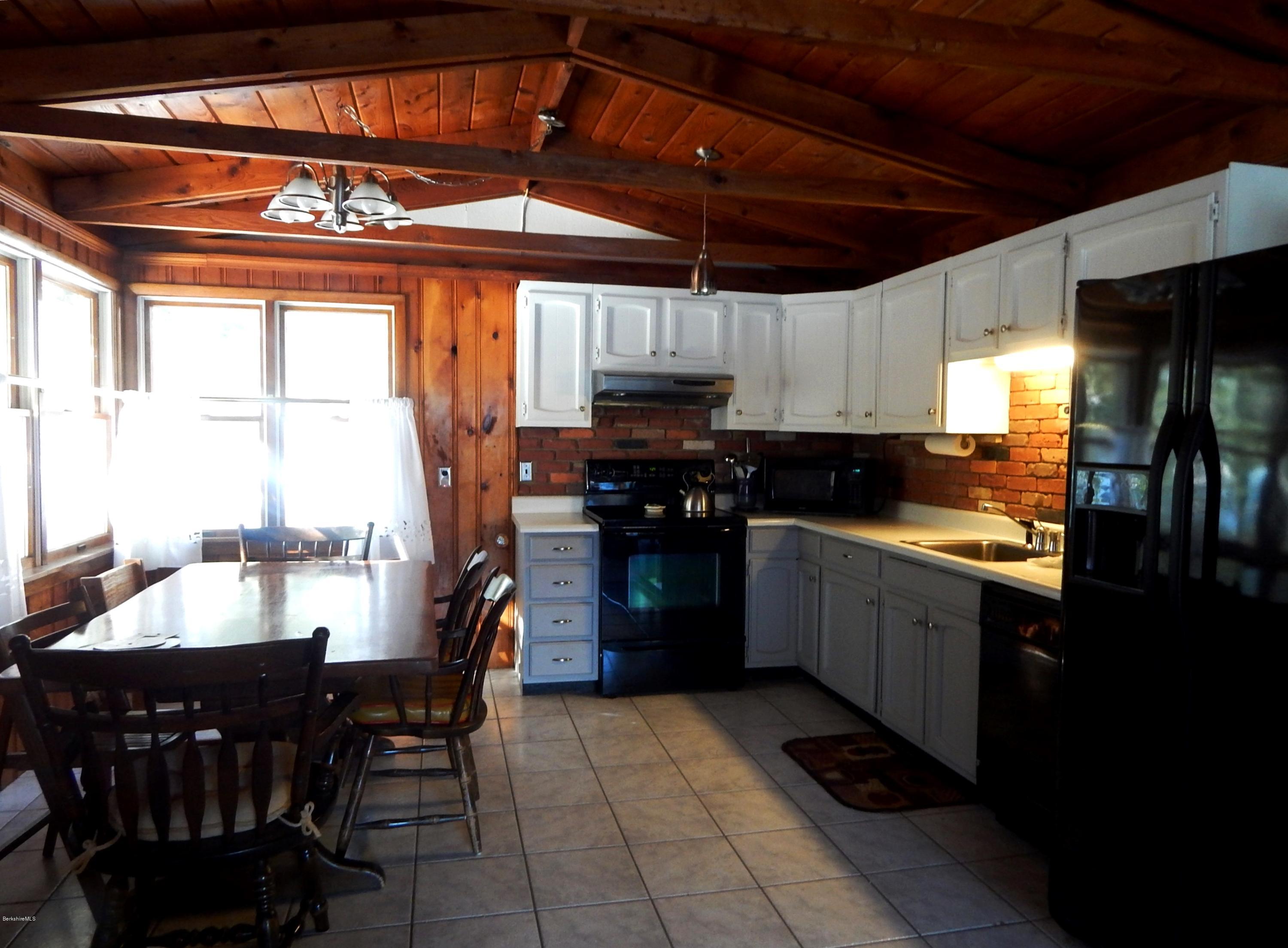 25 Point Road Monterey, MA 01245 - Photo 5 of 19 a kitchen with stainless steel appliances granite countertop a stove a sink and a refrigerator