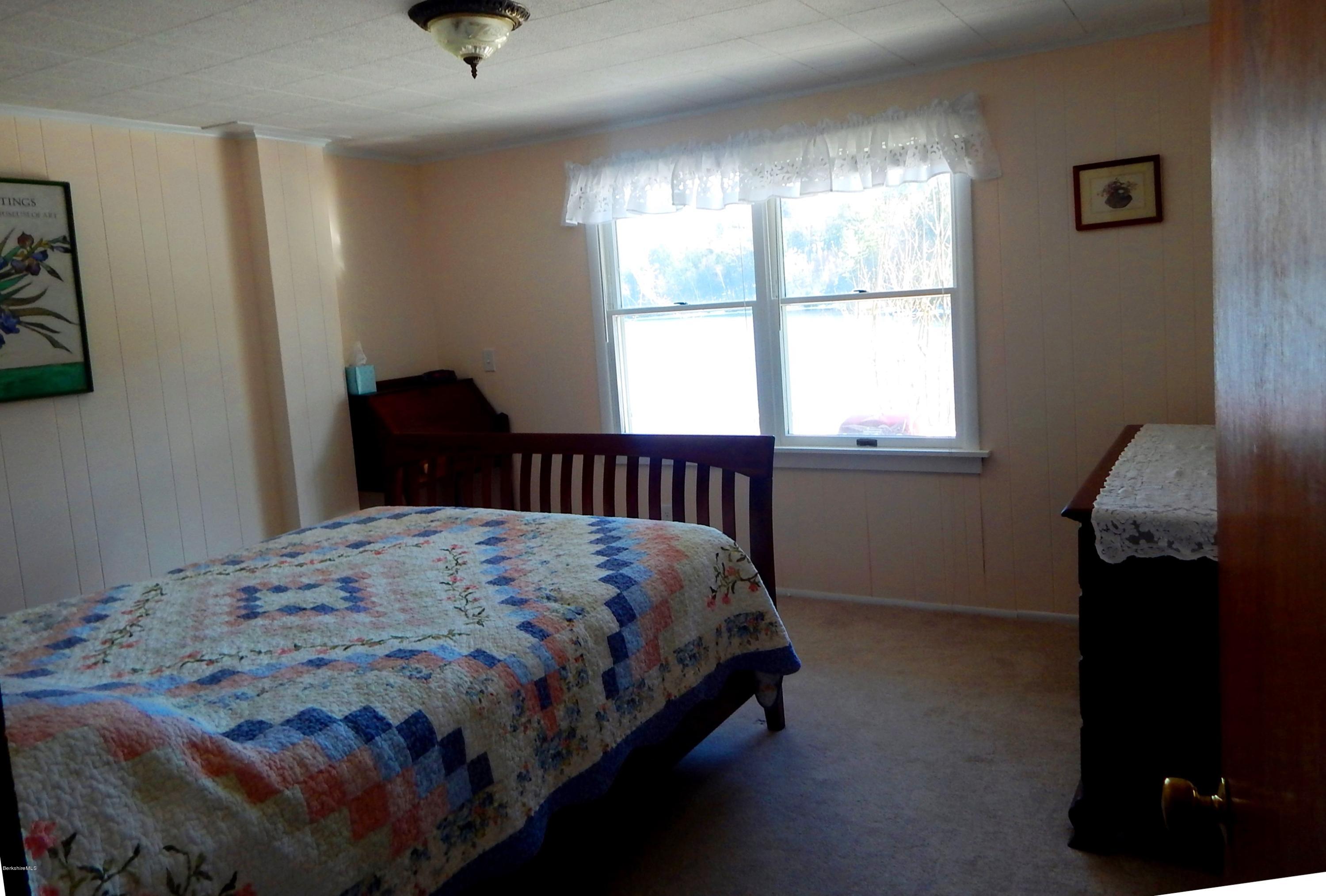 25 Point Road Monterey, MA 01245 - Photo 7 of 19 a bedroom with a bed and wooden floor