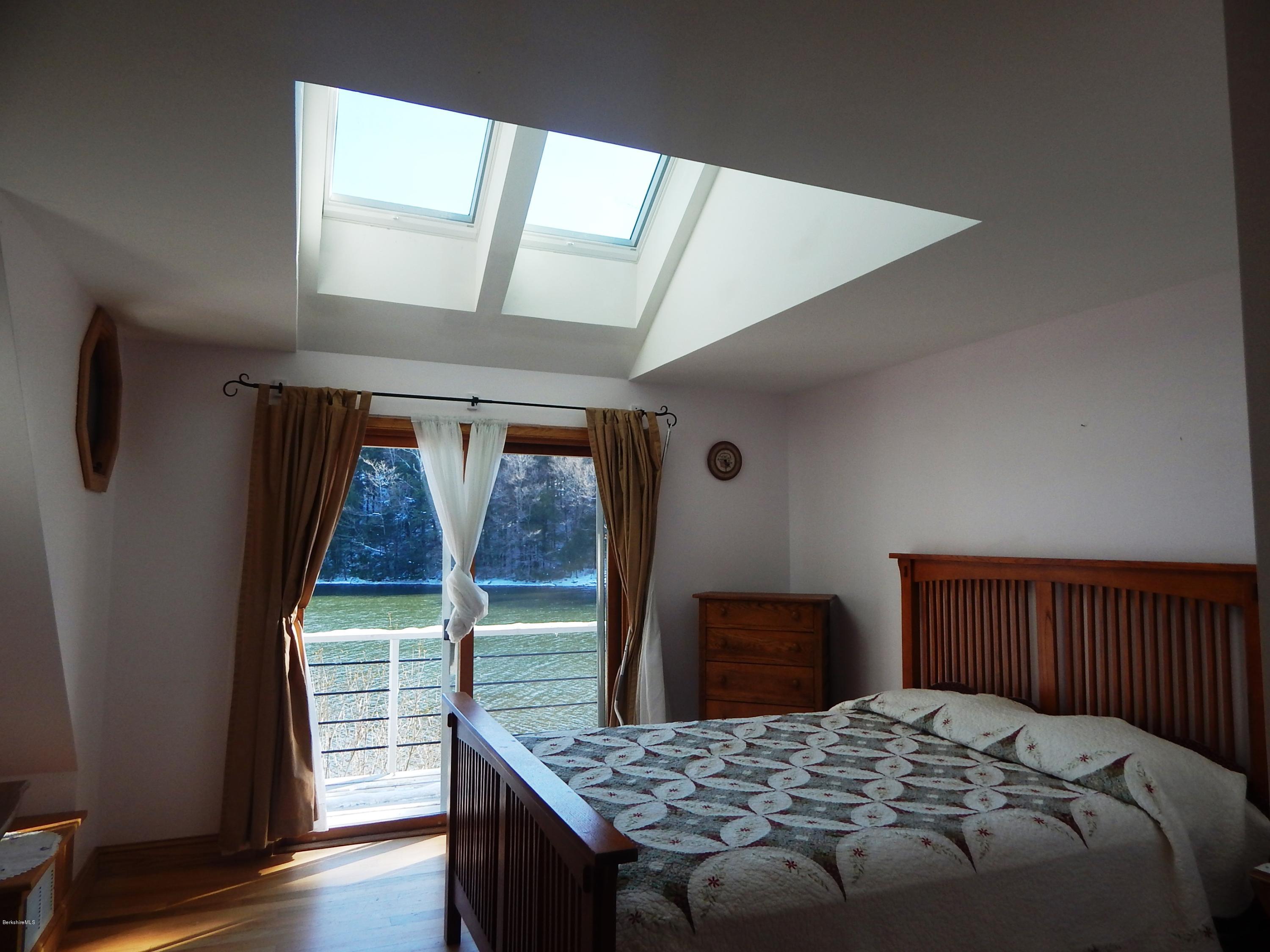 25 Point Road Monterey, MA 01245 - Photo 10 of 19 a bedroom with a bed and wooden floor