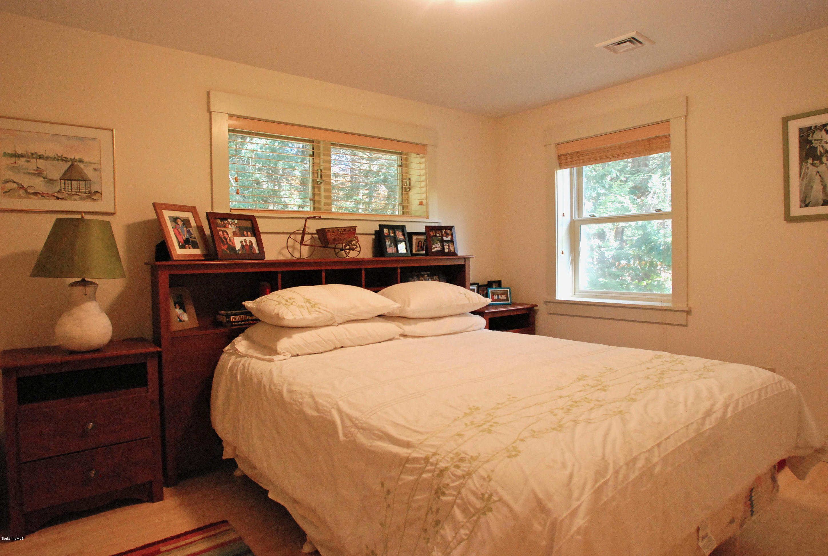 101 Tyringham Road Monterey, MA 01245 - Photo 22 of 36 a bed sitting in a bedroom next to a window