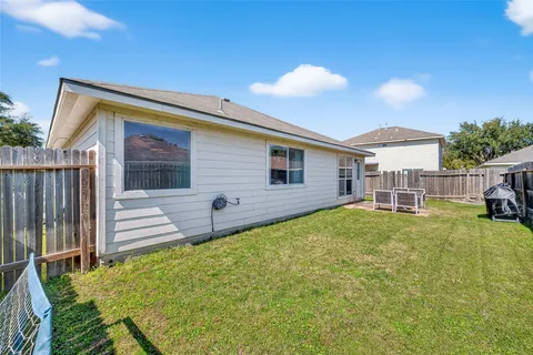 a view of a house with a backyard