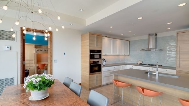 a kitchen with a sink and stainless steel appliances