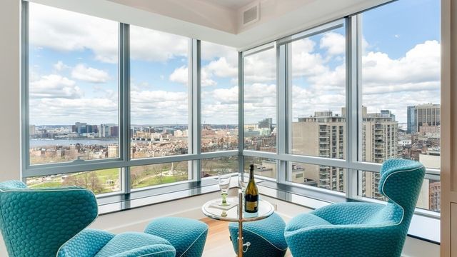 a living room with furniture and a floor to ceiling window
