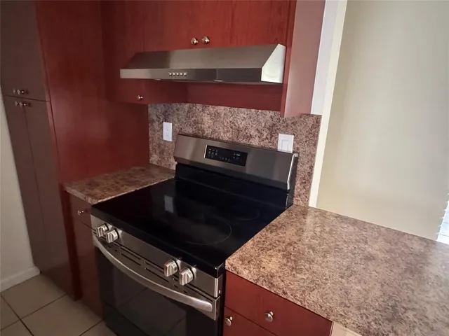 a kitchen with stainless steel appliances granite countertop a sink refrigerator and microwave