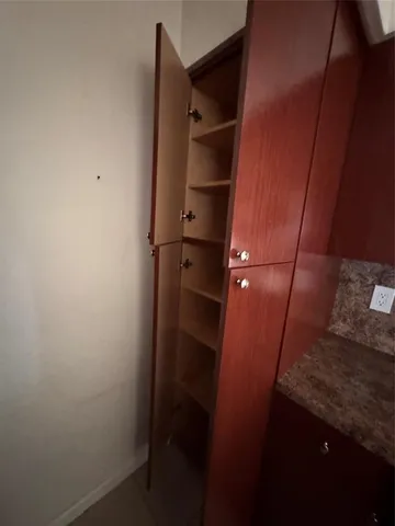 a bathroom with a granite countertop toilet a sink and a bathtub