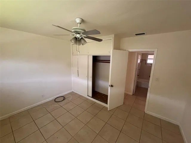 a bathroom with a shower and closet