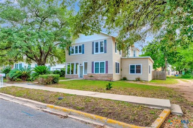 a front view of a house with a yard and porch