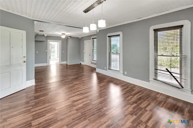 a view of a hallway with wooden floor