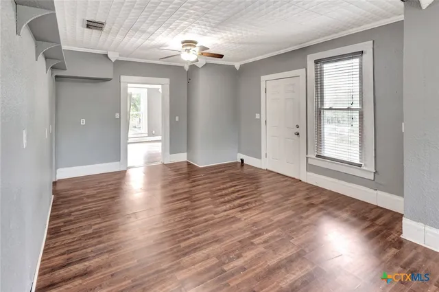 wooden floor in an empty room with a window