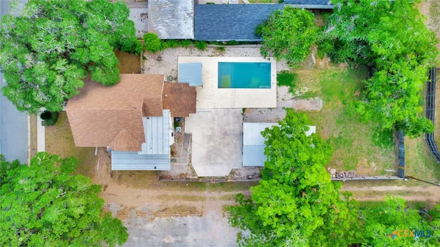 an aerial view of a house with a yard and a fountain