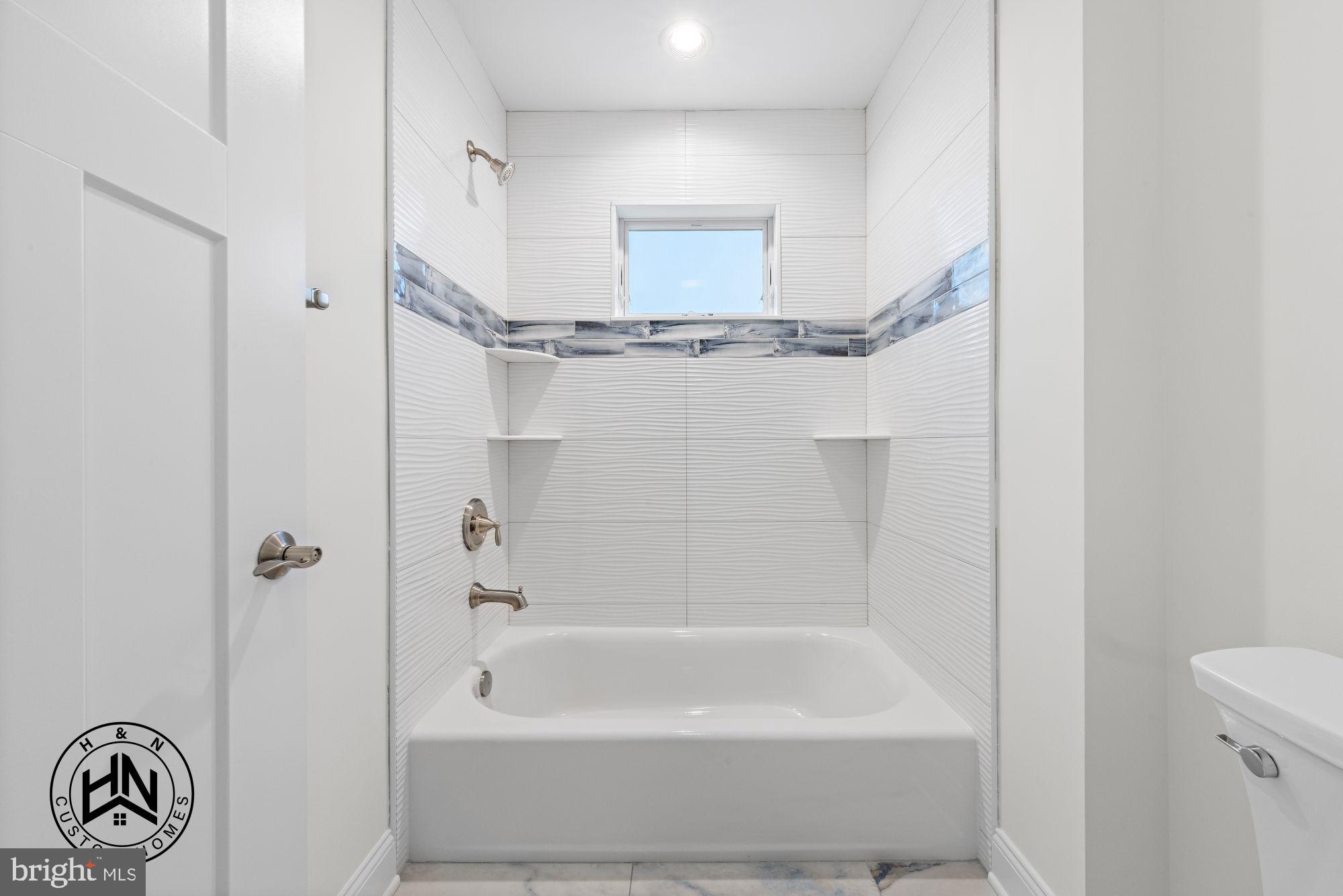 24 West 53rd Street Long Beach Township, NJ 08008 - Photo 53 of 75 a bathroom with a bathtub and a shower