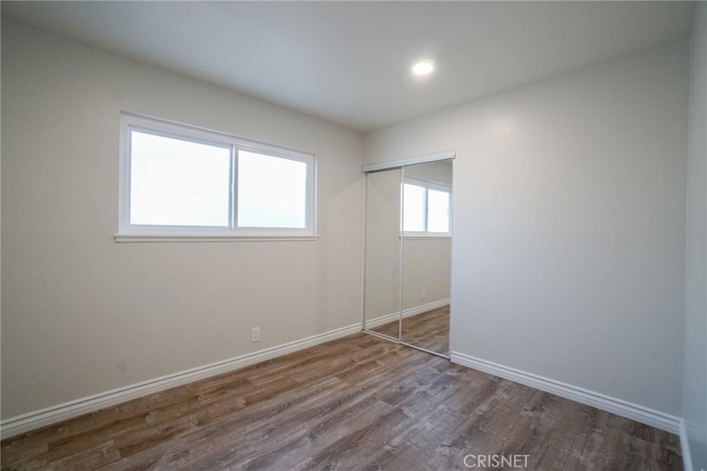 1108 Waltham Road Simi Valley, CA 93065 - Photo 12 of 25 an empty room with wooden floor and windows