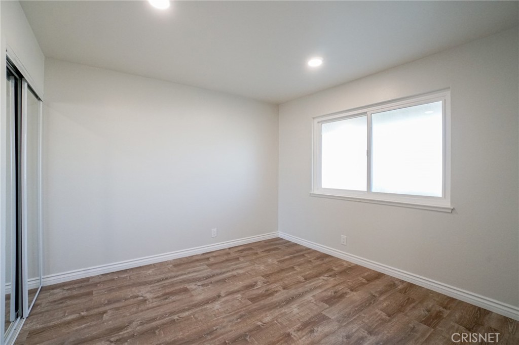 1108 Waltham Road Simi Valley, CA 93065 - Photo 13 of 25 an empty room with wooden floor and windows