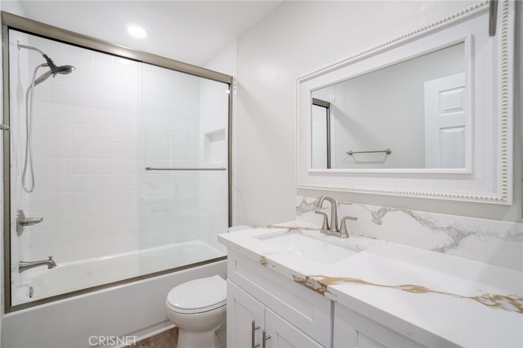 1108 Waltham Road Simi Valley, CA 93065 - Photo 16 of 25 a bathroom with a granite countertop sink toilet and shower