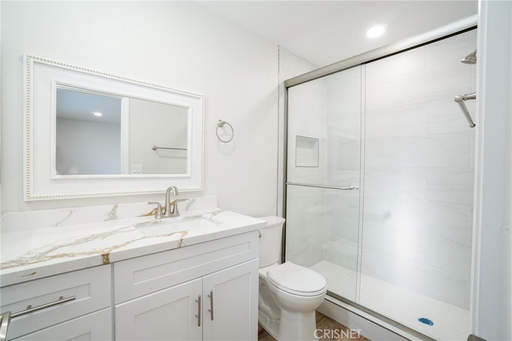1108 Waltham Road Simi Valley, CA 93065 - Photo 17 of 25 a bathroom with a shower sink vanity mirror and toilet