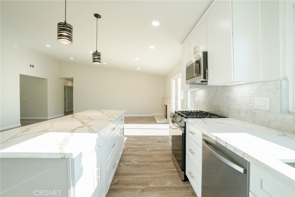 1108 Waltham Road Simi Valley, CA 93065 - Photo 4 of 25 a spacious kitchen with stainless steel appliances granite countertop a sink a stove and a refrigerator