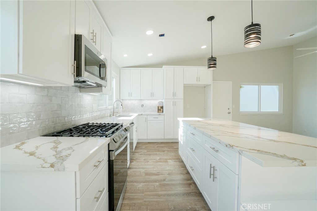 1108 Waltham Road Simi Valley, CA 93065 - Photo 7 of 25 a kitchen with a stove a sink and a refrigerator