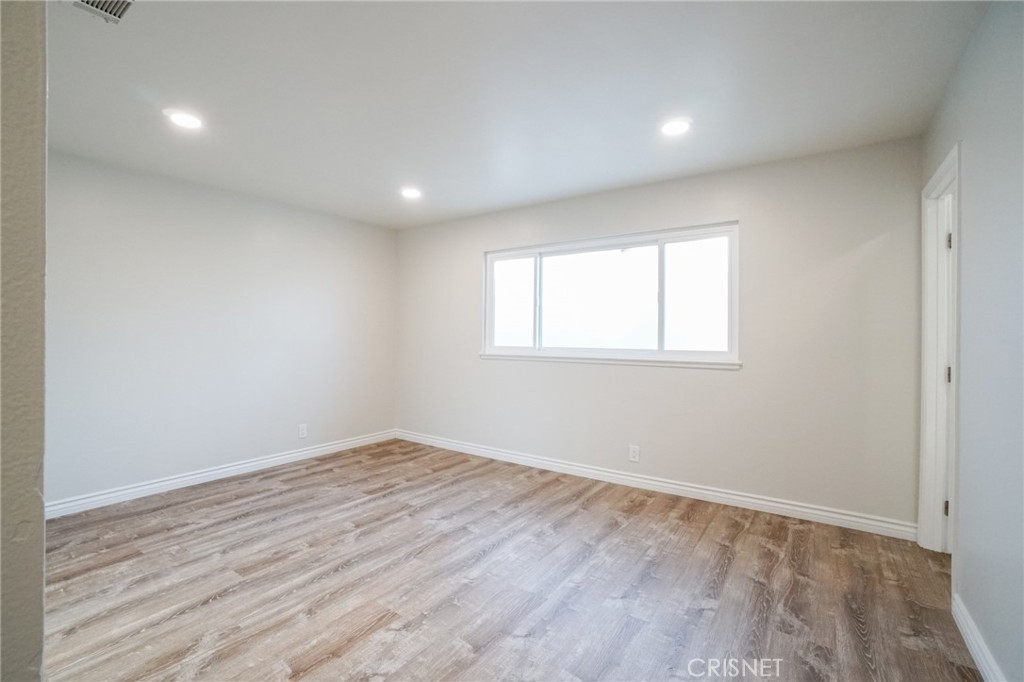 1108 Waltham Road Simi Valley, CA 93065 - Photo 8 of 25 an empty room with wooden floor and windows