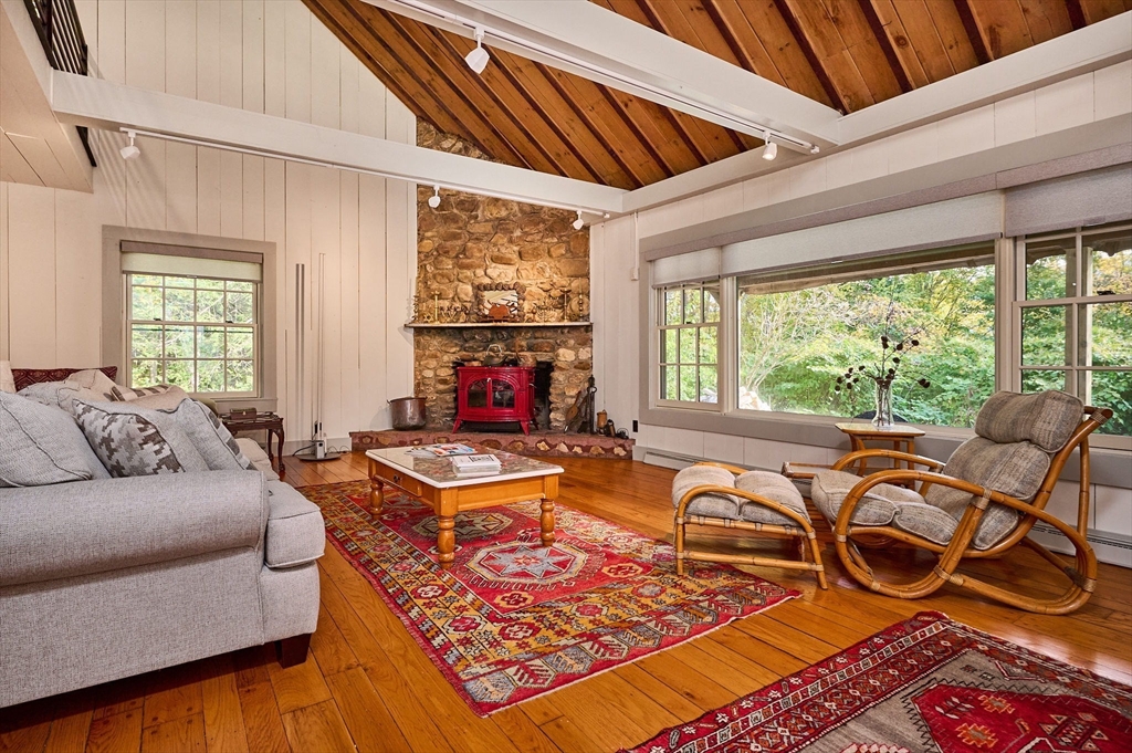 10 Walker Road Buckland, MA 01370 - Photo 5 of 41 a living room with furniture a flat screen tv and a large window