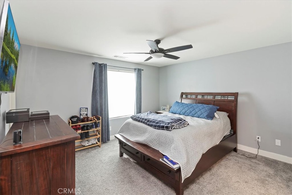 425 North Beechwood Avenue Rialto, CA 92376 - Photo 17 of 33 a bedroom with a bed and a chandelier