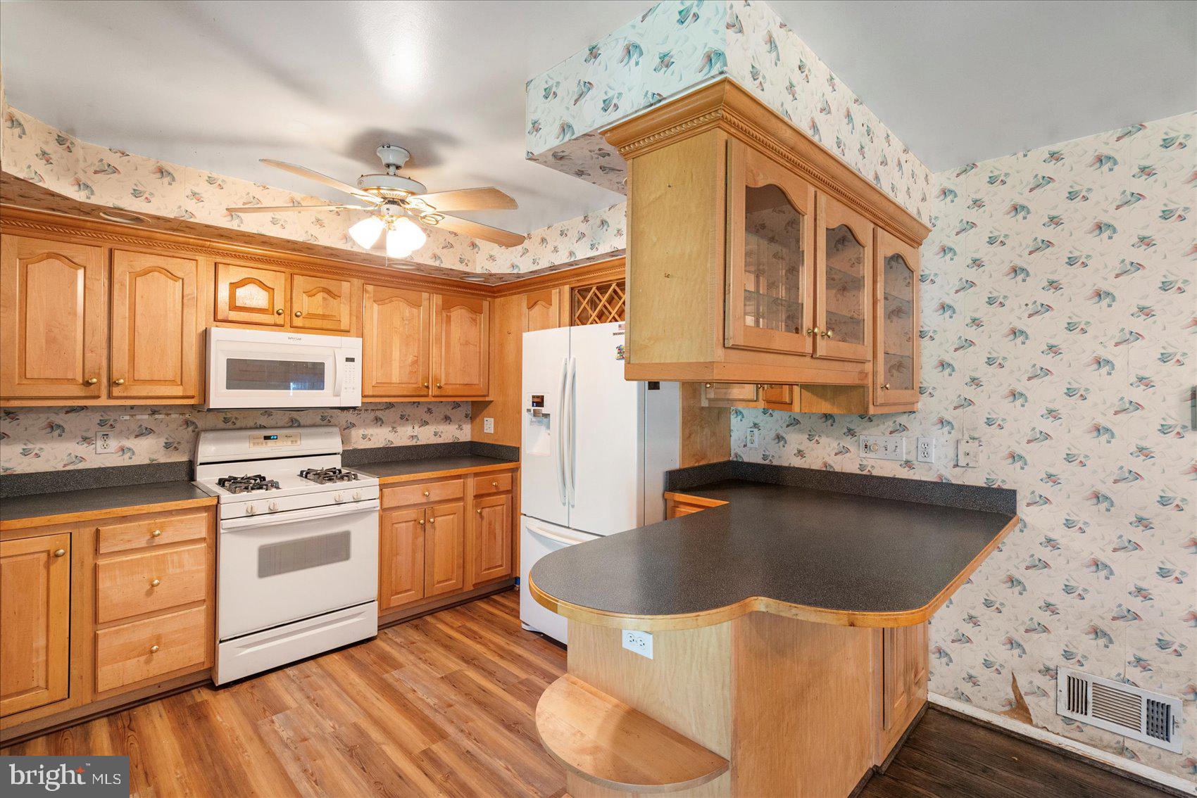 8261 Spring Knoll Drive Pasadena, MD 21122 - Photo 14 of 49 a kitchen with stainless steel appliances granite countertop a sink a stove a refrigerator and island