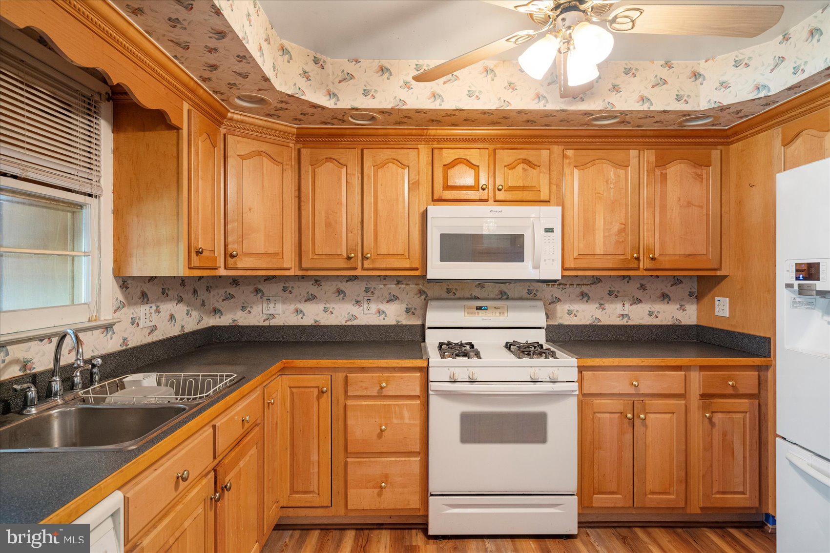 8261 Spring Knoll Drive Pasadena, MD 21122 - Photo 15 of 49 a kitchen with granite countertop a sink and cabinets