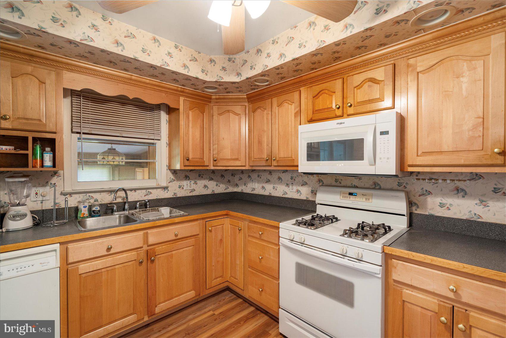 8261 Spring Knoll Drive Pasadena, MD 21122 - Photo 16 of 49 a kitchen with stainless steel appliances granite countertop a sink stove and cabinets