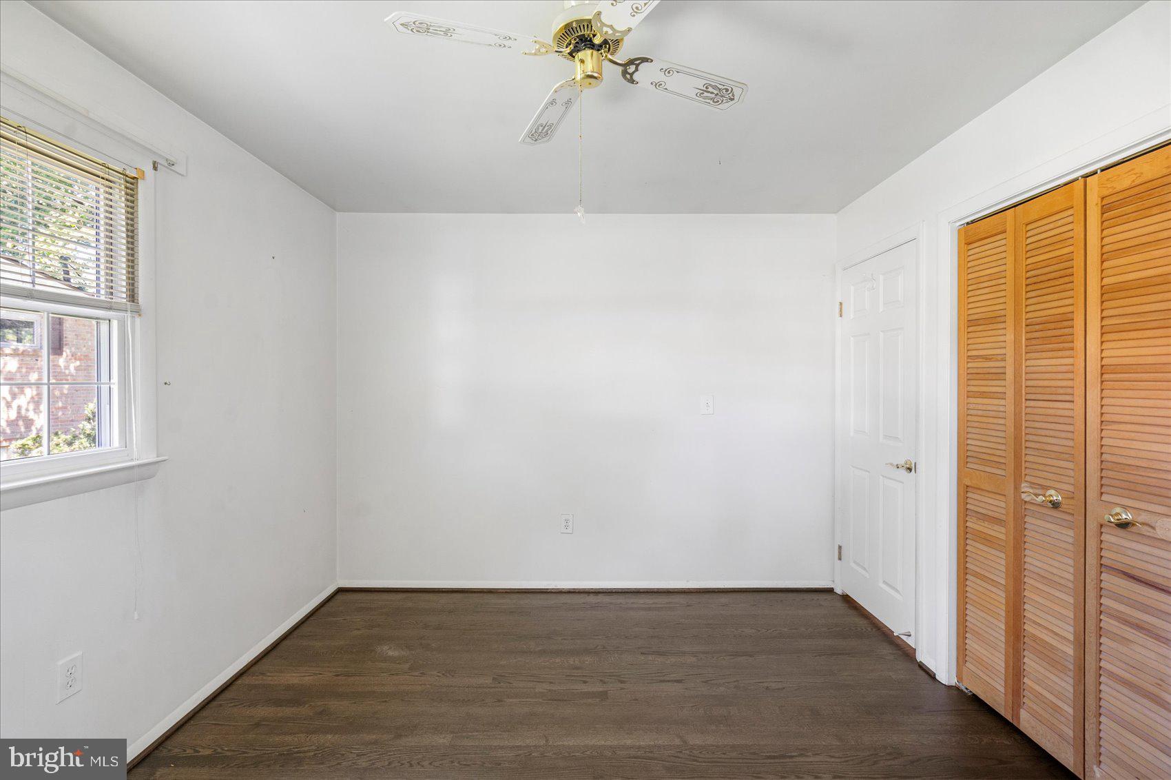 8261 Spring Knoll Drive Pasadena, MD 21122 - Photo 19 of 49 wooden floor in an empty room with a window