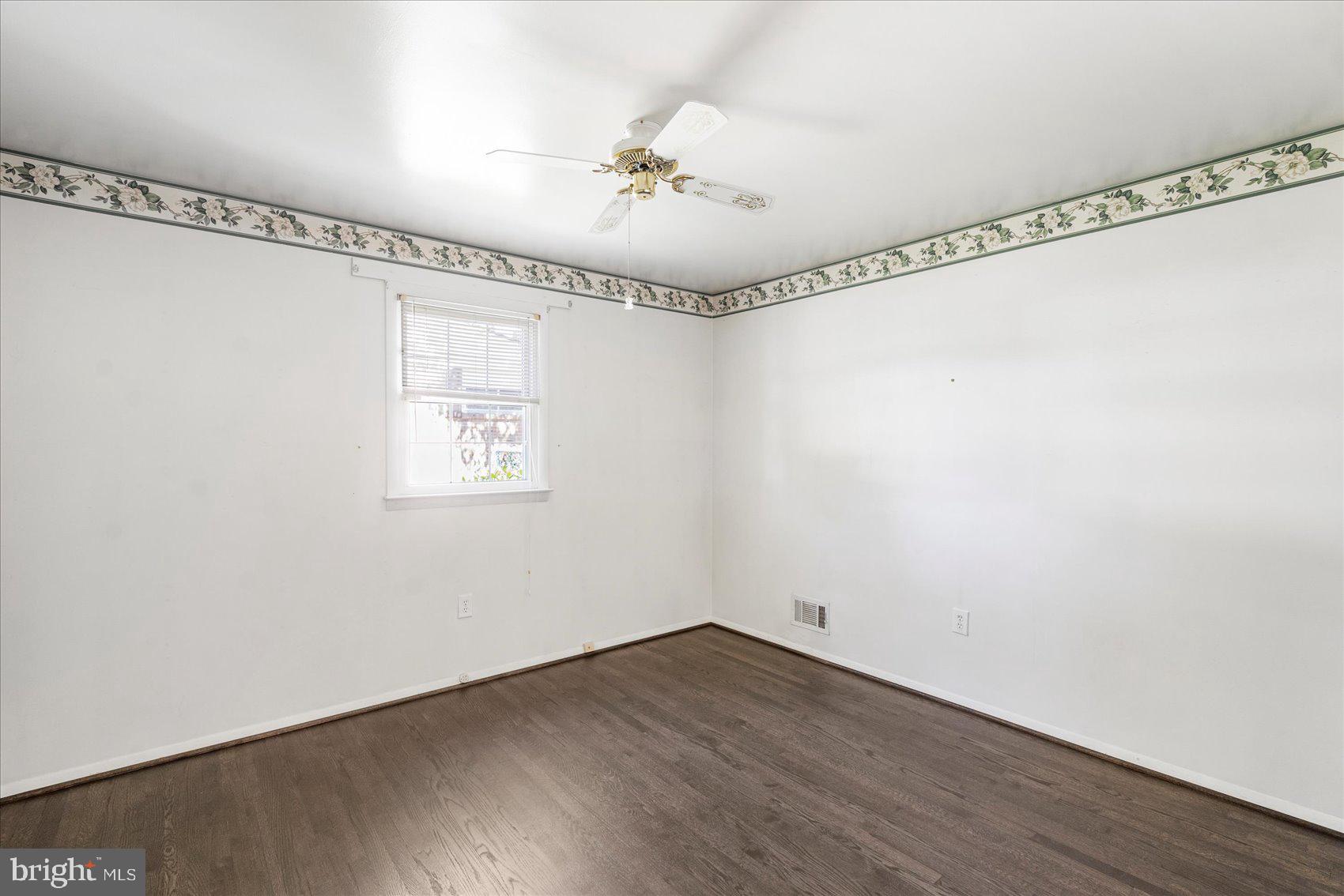 8261 Spring Knoll Drive Pasadena, MD 21122 - Photo 20 of 49 a view of a room with wooden floor fan and windows