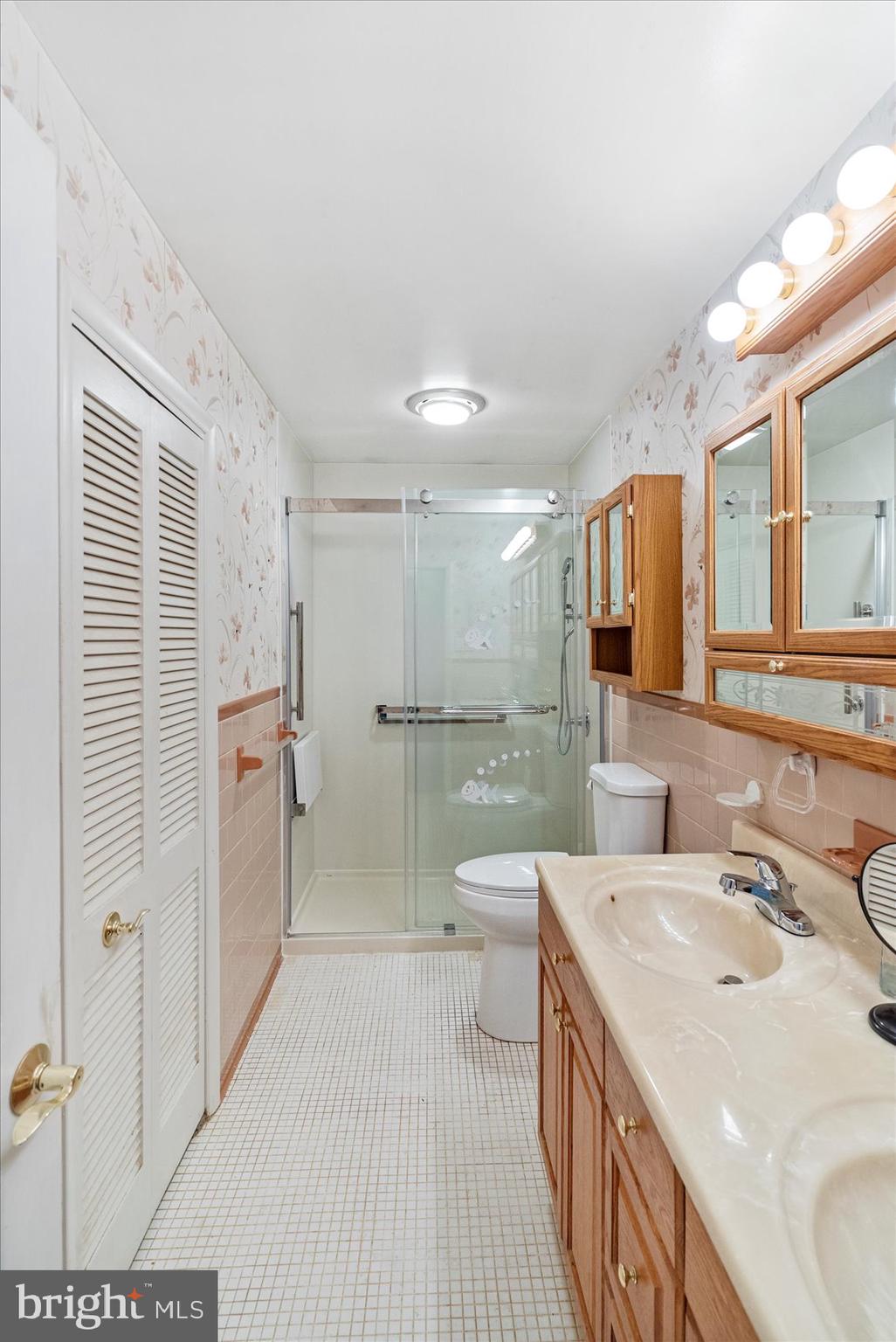 8261 Spring Knoll Drive Pasadena, MD 21122 - Photo 26 of 49 a bathroom with a sink a toilet and mirror