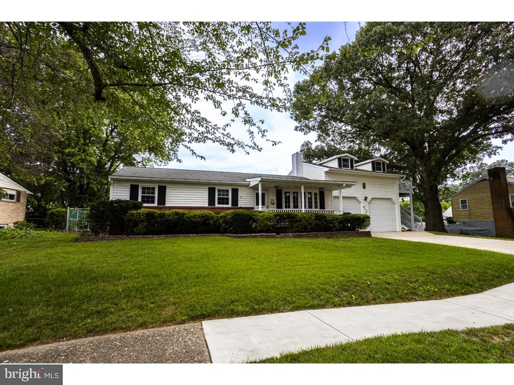 8261 Spring Knoll Drive Pasadena, MD 21122 - Photo 3 of 49 a front view of a house with a garden