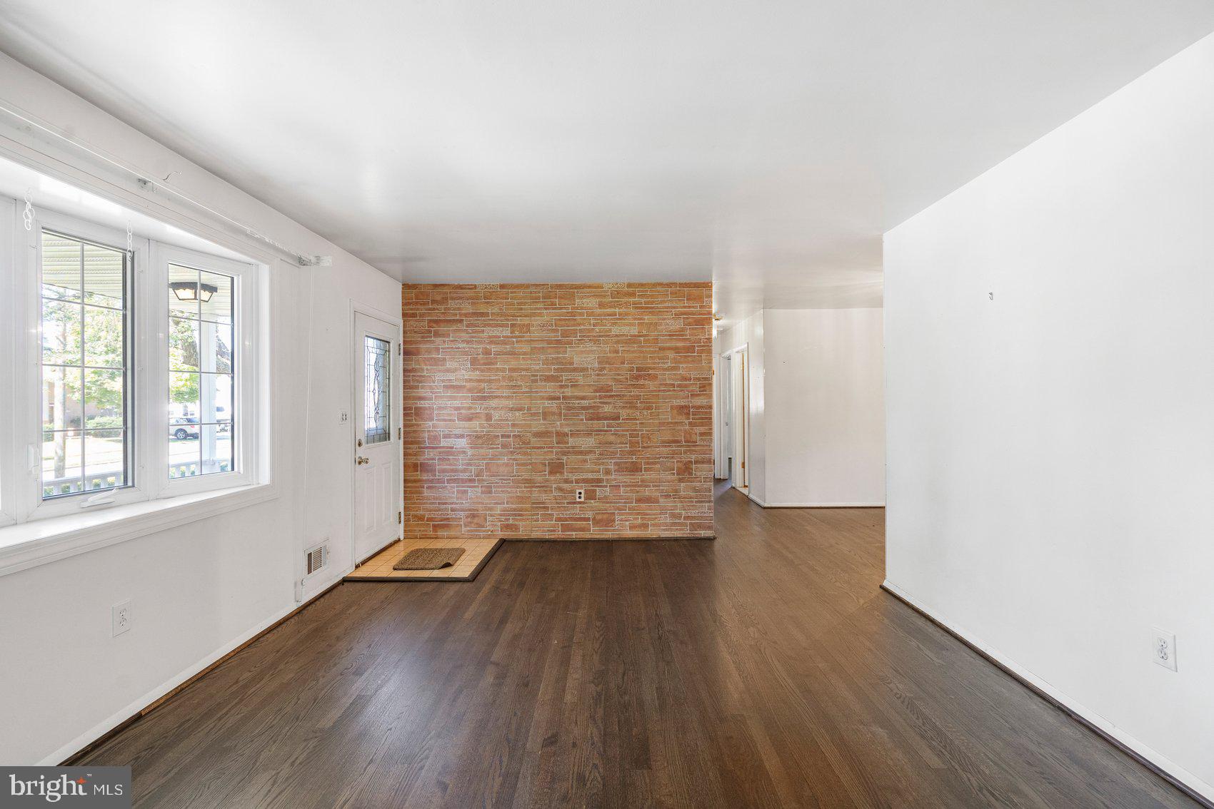8261 Spring Knoll Drive Pasadena, MD 21122 - Photo 9 of 49 an empty room with wooden floor and windows