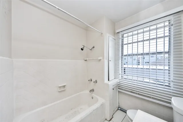 a bathroom with a bathtub and shower