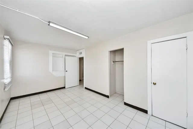 a view of a hallway to rooms