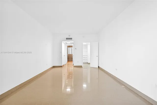 a bathroom with a sink a toilet a mirror and shower